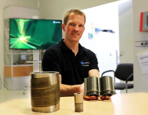 Laserline employee presenting three laser cladding samples by Laserline diode lasers