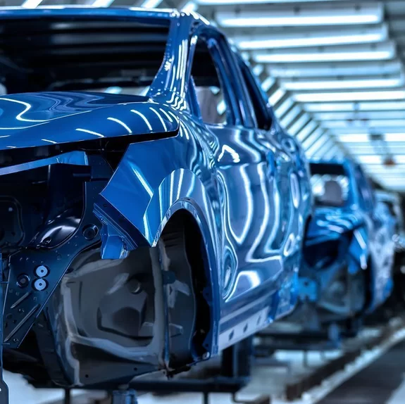 Row of finished car bodies in a production site welded together with laser by Laserline diode lasers